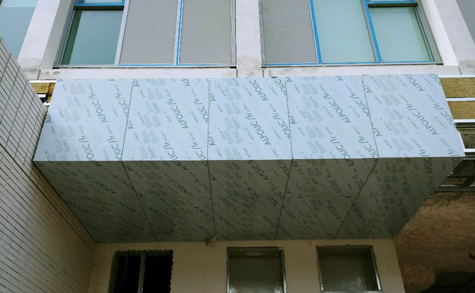 Aluminum composite ACM panel facade being installed on a commercial building in Vancouver BC
